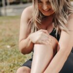 woman holding sore legs
