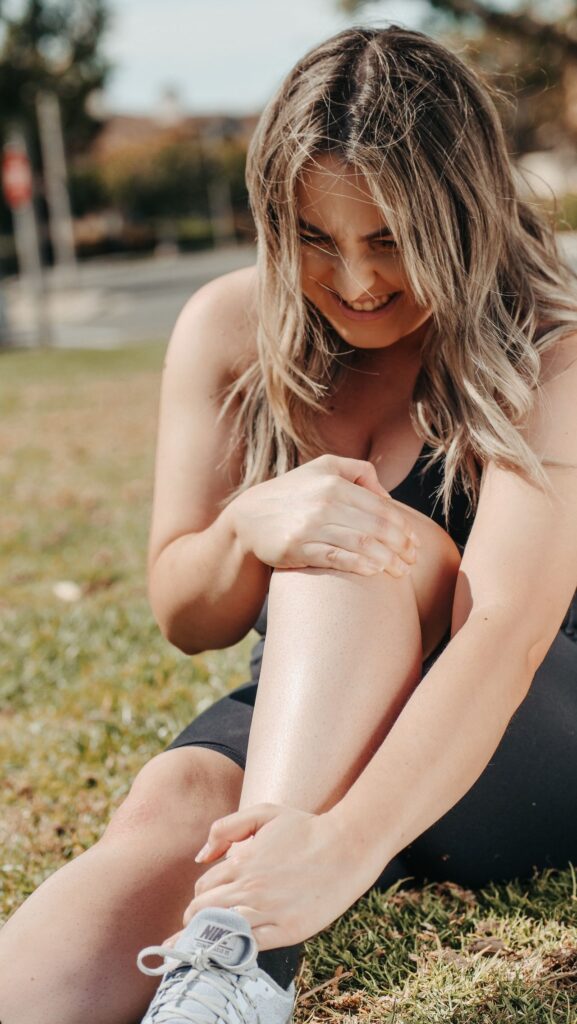 woman holding sore legs